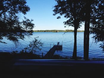 Scenic view of lake against clear blue sky