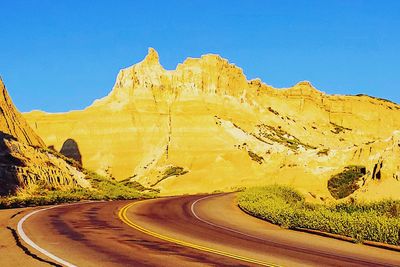 Scenic view of mountains against clear blue sky