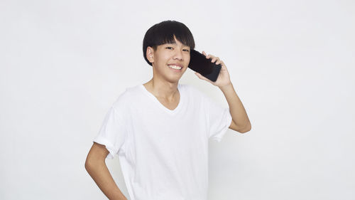 Portrait of smiling mid adult man against white background