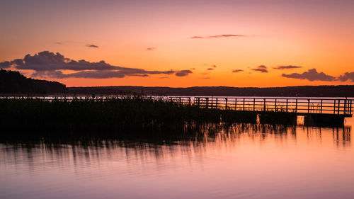 Scenic view of lake against orange sky