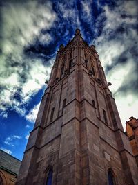 Low angle view of building against cloudy sky