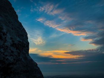 Low angle view of rock formation against sky during sunset