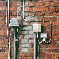 Electrical boxes mounted on brick wall