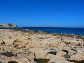 Scenic view of sea against clear blue sky