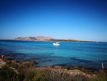 Scenic view of sea against clear blue sky