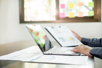 Cropped image of business colleagues working on table