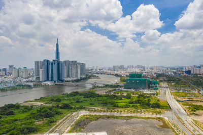 Aerial view of buildings in city against sky