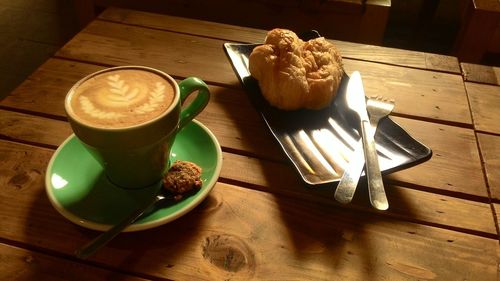 High angle view of coffee and cups on table