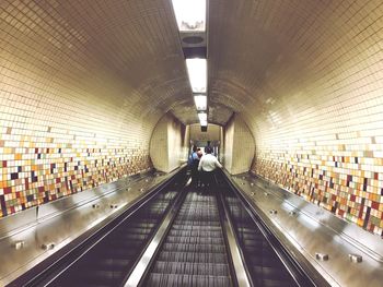 People walking on illuminated subway station