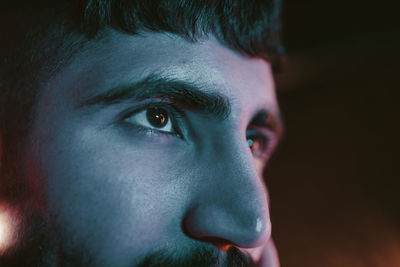 Cropped image of young man looking away at bar