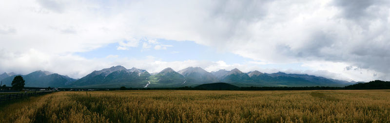 Panoramic shot of land and mountains against sky