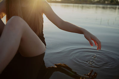 Midsection of girl in lake