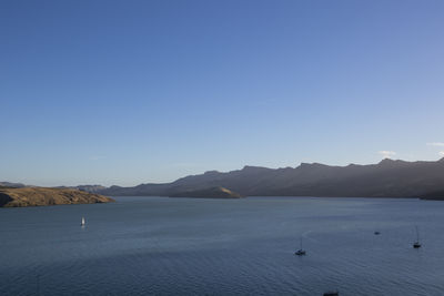 Scenic view of sea against clear blue sky