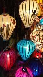 Close-up of illuminated lanterns hanging at night
