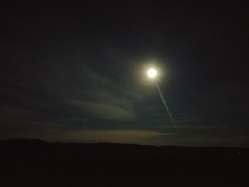 Low angle view of silhouette moon against sky at night
