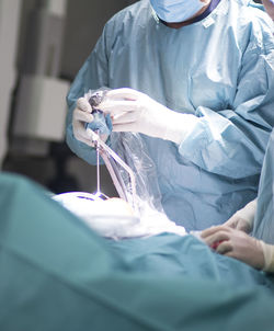 Midsection of surgeons working in operating room