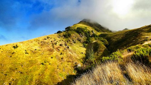 Scenic view of mountains against cloudy sky