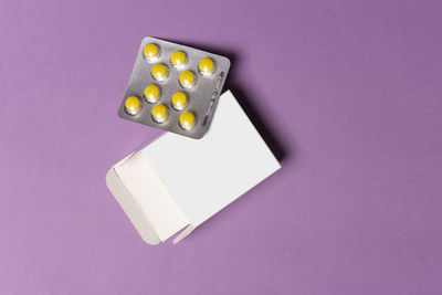 High angle view of pills on blue background