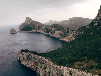 High angle view of sea and mountains against sky