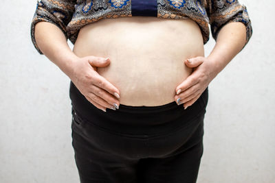 Midsection of woman holding hands