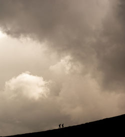 Low angle view of silhouette landscape against sky