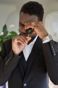 Portrait of young man looking at a gold ring with a safire 