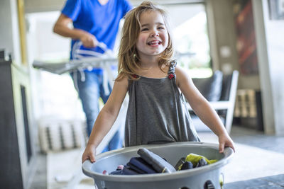 Portrait of smiling girl standing in kitchen