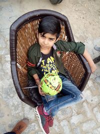 High angle portrait of a girl sitting outdoors