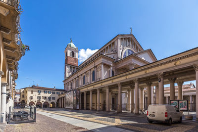 Buildings against clear blue sky in city