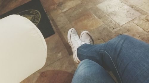 Low section of man standing on hardwood floor