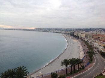 Panoramic view of city by sea against sky