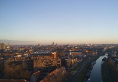 High angle view of buildings against clear sky during sunset