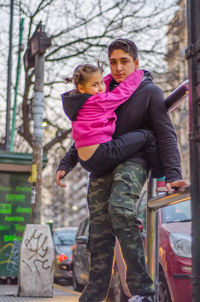 Father and son in city during winter