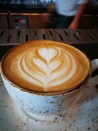 Close-up of cappuccino on table