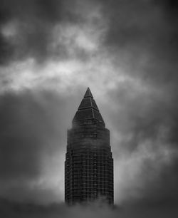 Low angle view of building against cloudy sky