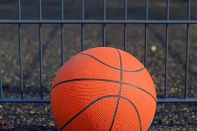 Close-up of basketball against fence