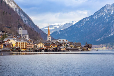 View of beautiful hallstatt lake and famous church during morning sunrise in early spring