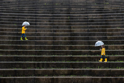 Full length of man working on staircase