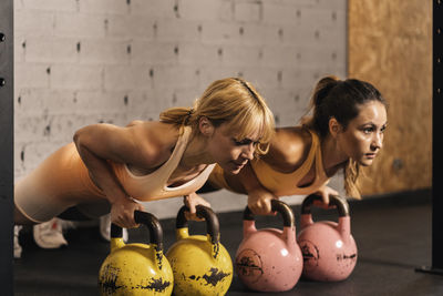 Couple of female athletes concentrated a training session in a gym  hall effort and improvement