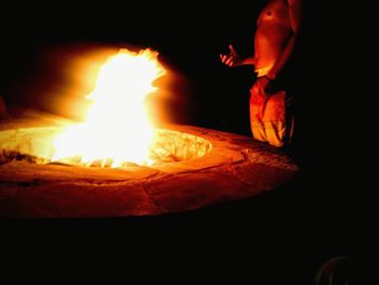 Close-up of burning candle on table