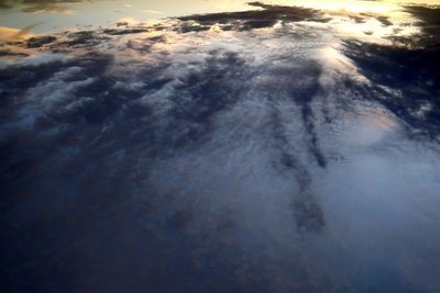 Aerial view of sea against cloudy sky