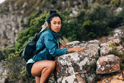 Woman looking away while rock climbing