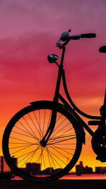 Bicycle against sky during sunset