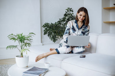 Young woman using laptop at home