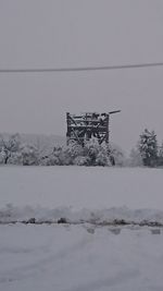 Snow on field against sky during winter