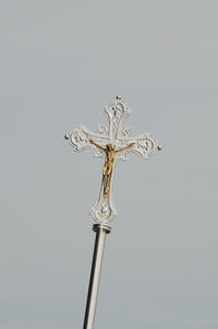 Close-up of cross against white background