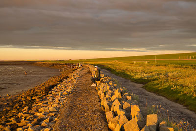 Scenic view of land against sky during sunset