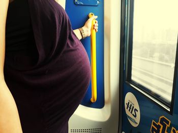 Rear view of man standing by train window