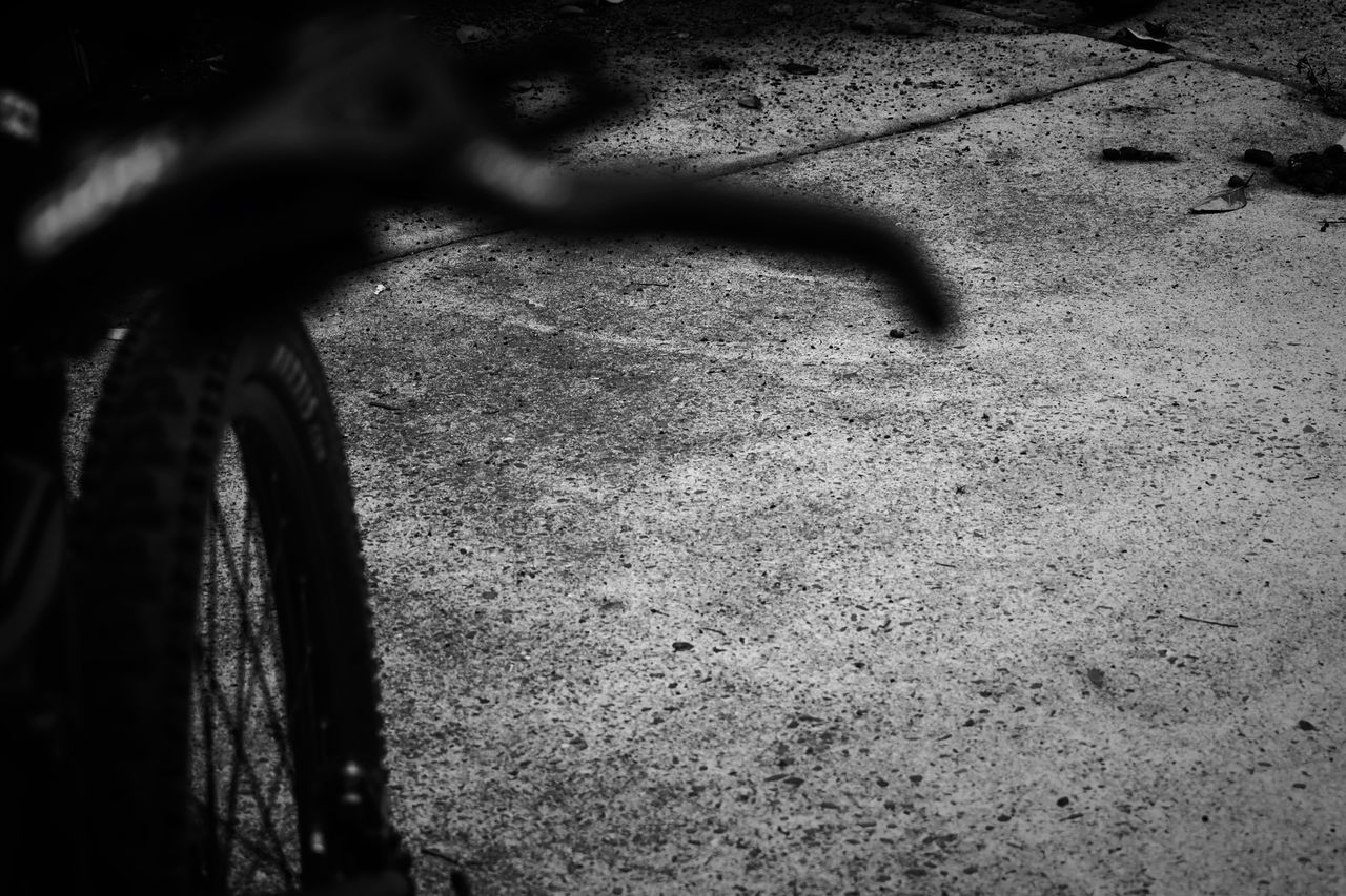 CLOSE-UP OF BICYCLE WITH SHADOW ON BACKGROUND