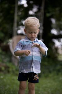 Portrait of boy standing outdoors